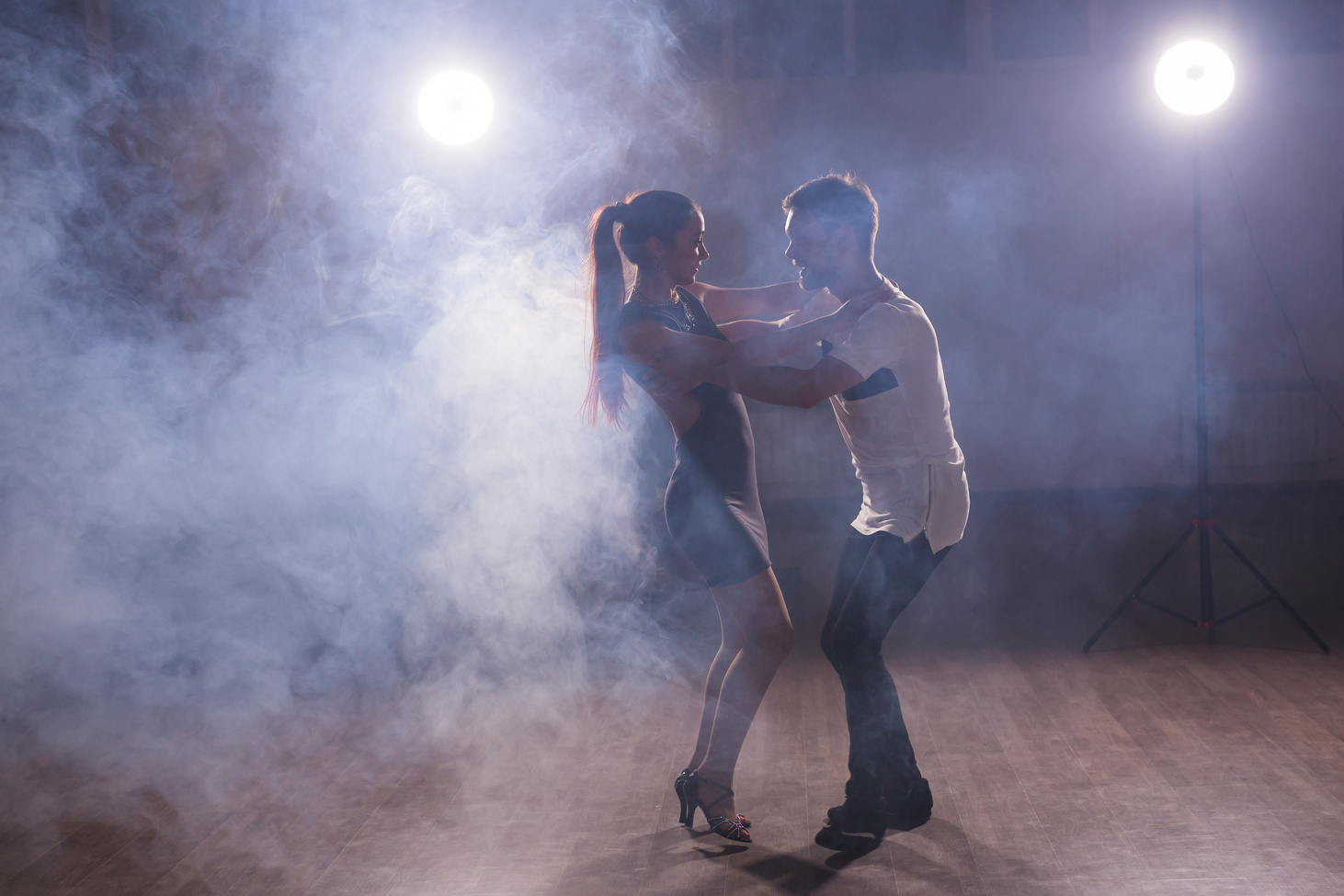 Young Couple Dancing Latin Dance Bachata, Merengue, Salsa. Two Elegance Pose in Dance Class