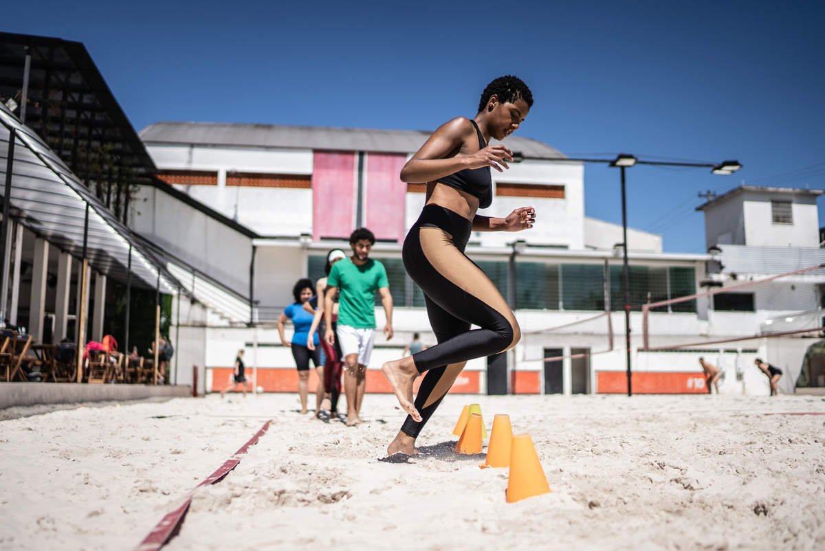 Woman training in a sand court