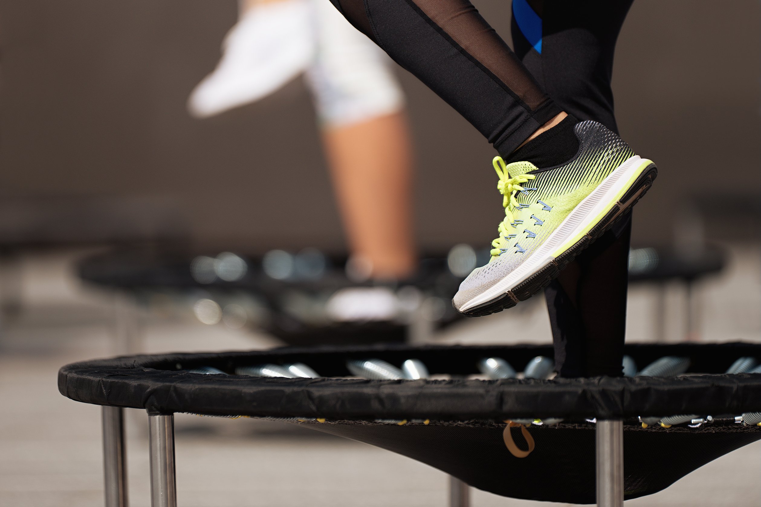 Fitness women jumping on small trampolines